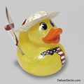 Yellow rubber duck with a straw hat, umbrella, and American flag design on a white background.