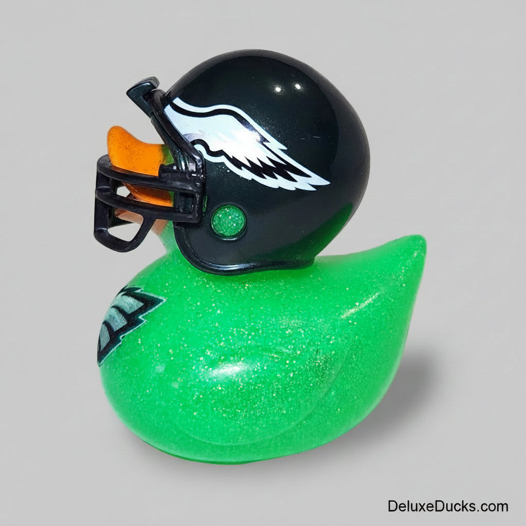 Green glittery rubber duck with a black helmet on a white background