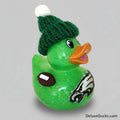 Green rubber duck with a knitted hat and sports logo on a beige background