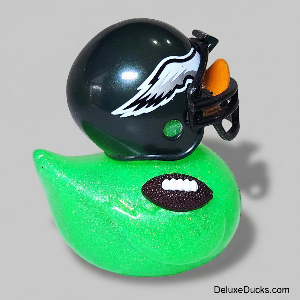 Green rubber duck with a football design and a black helmet with a logo on a white background