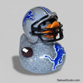 Rubber duck with football helmet and decorative elements on a gray background
