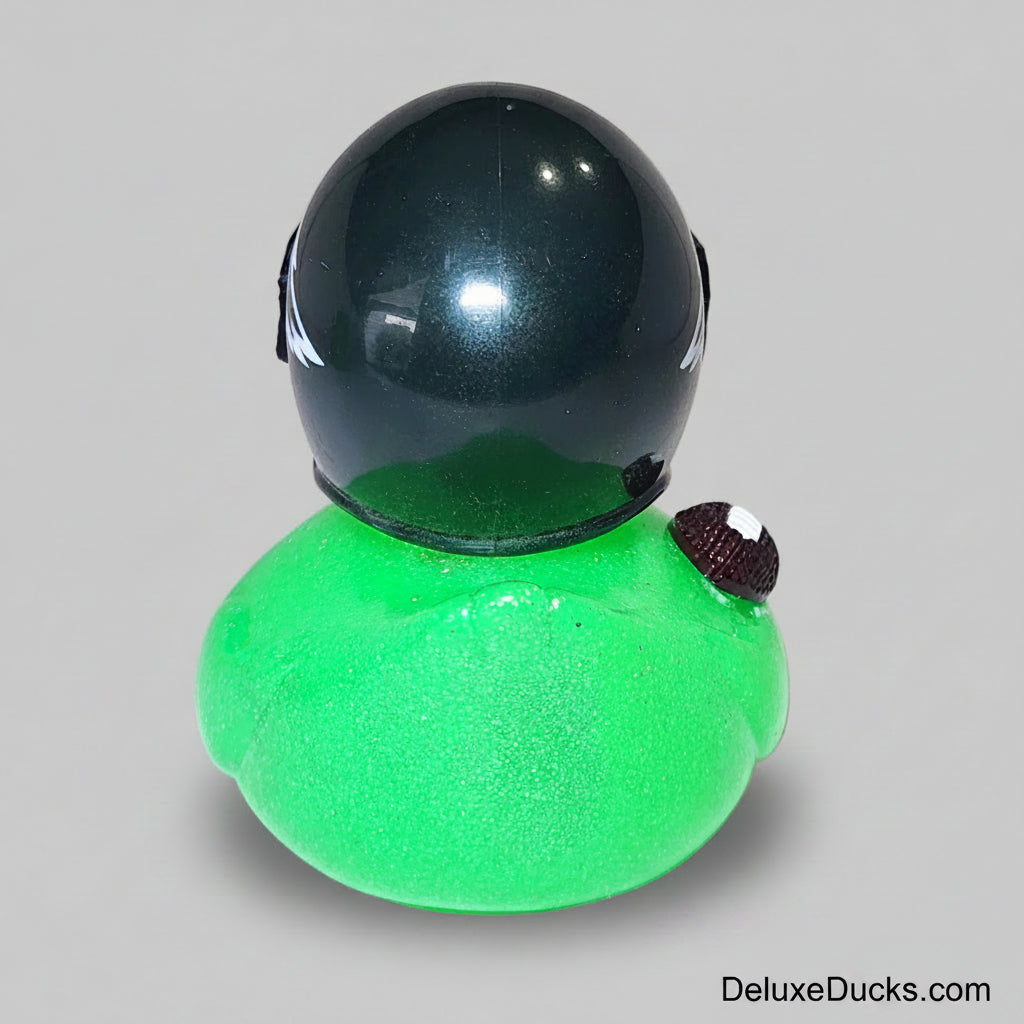 Green rubber duck with a black helmet on a gray background