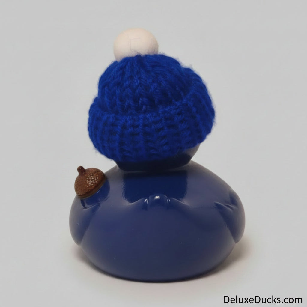 Blue rubber duck with a knitted hat on a gray background