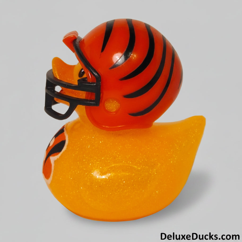 Rubber duck with orange and black striped helmet on a gray background