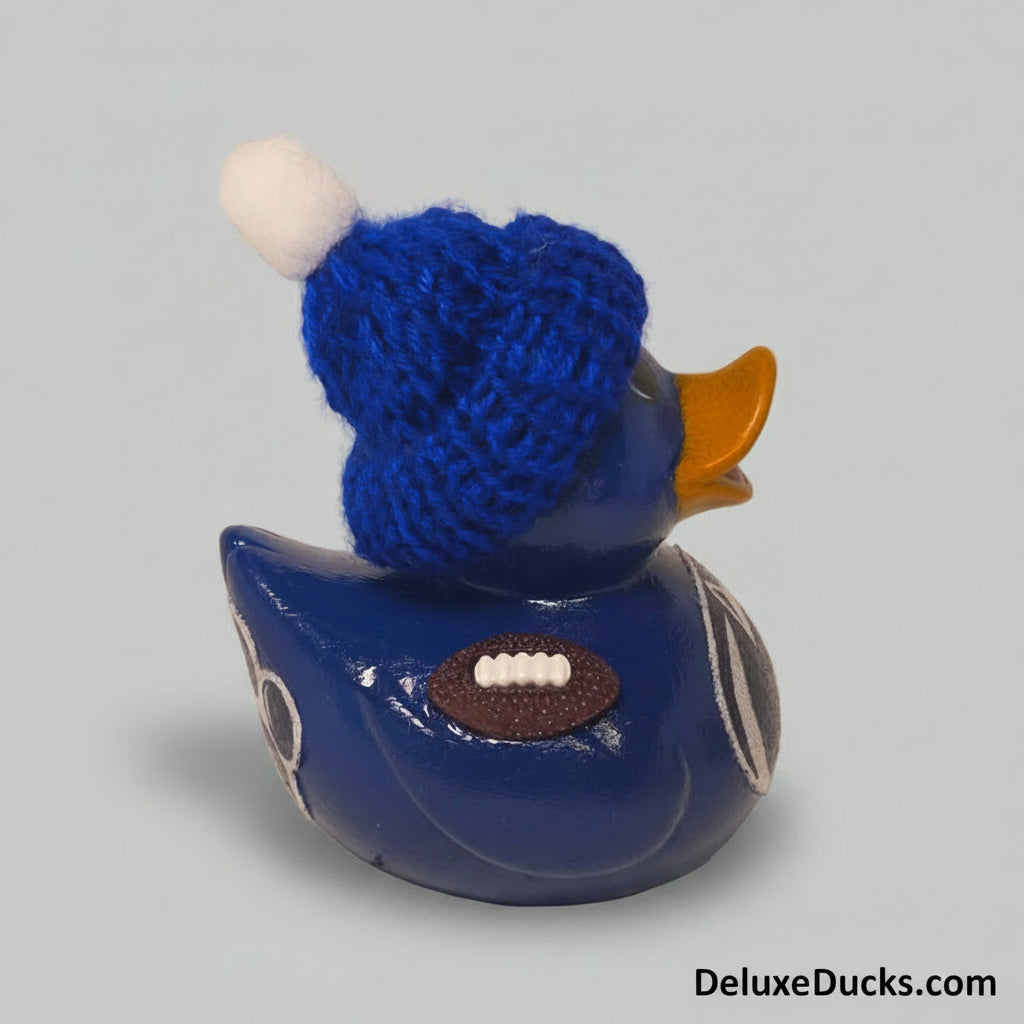 Blue rubber duck with a blue knitted hat on a gray background
