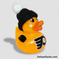 Rubber duck with a black knit hat and hockey team logo on a gray background