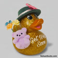 Decorative duck with a hat, flowers, and a teddy bear, featuring 'Get Well Soon' text on a gray background.