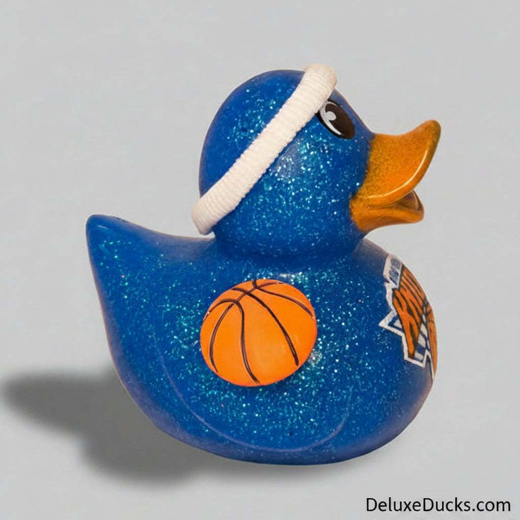Blue glittery duck-shaped object with a basketball design on a beige background