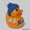 An orange glittery rubber duck with a blue knit beanie hat and a white baseball patch, featuring the Mets logo on its side, set against a plain light background.