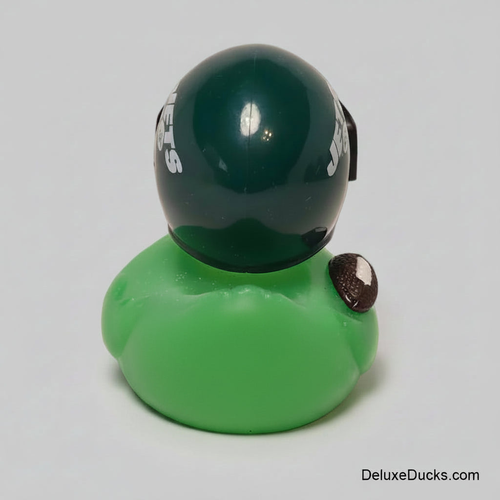 A green duck-shaped collectible figure with a dark green helmet on top, featuring a glittery green body and a small black-and-white eye detail, shown against a plain light gray background.